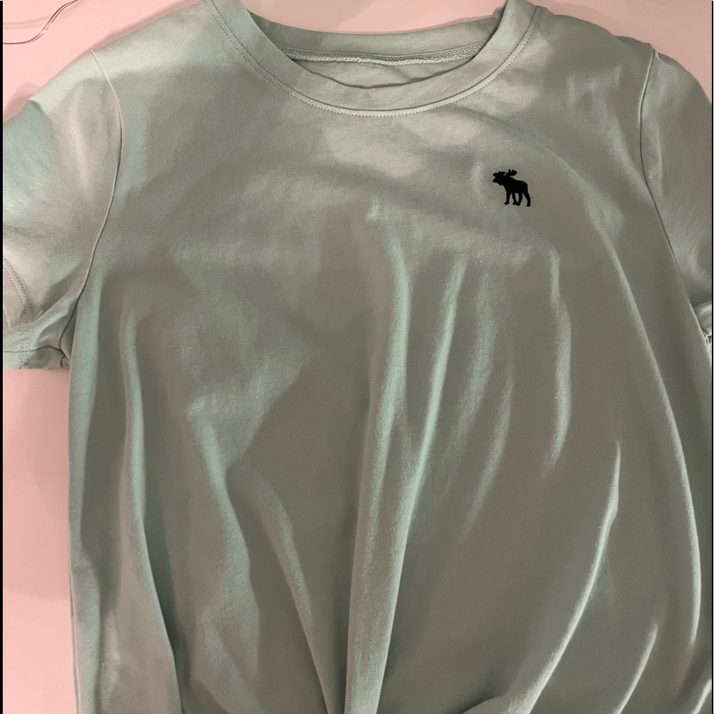 green shirt with tye at the bottom